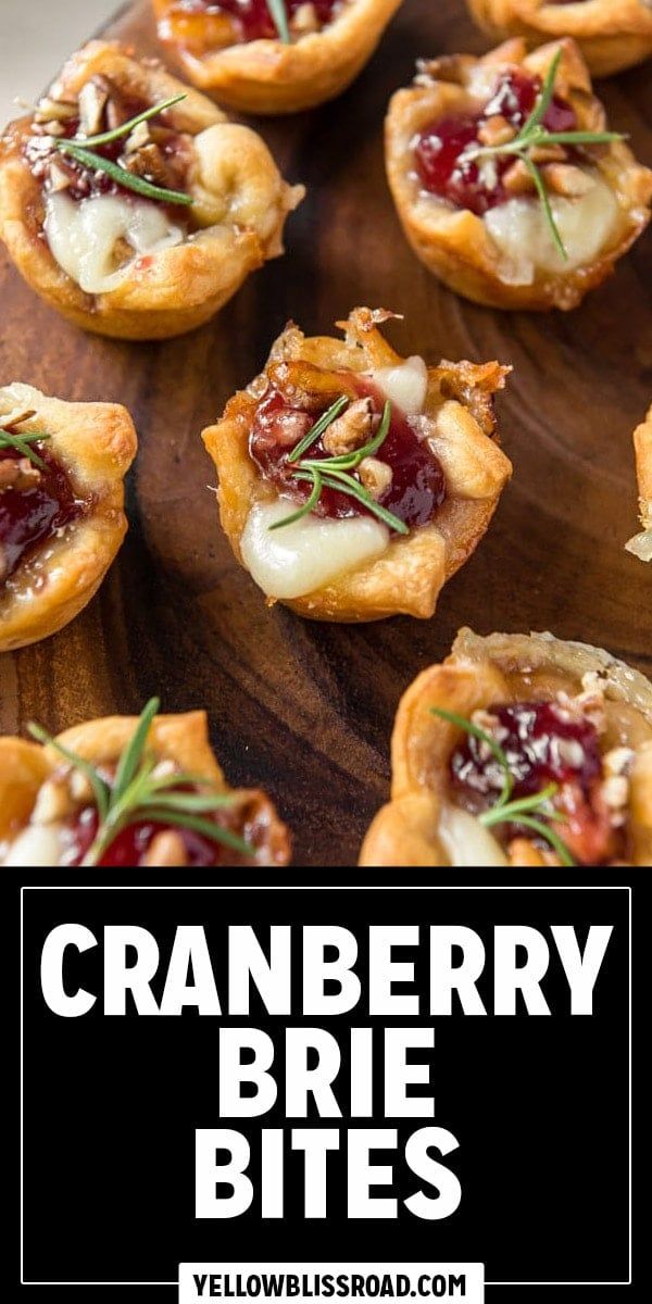 cranberry brie bites on a wooden platter with text overlay that reads, cranberry brie bites