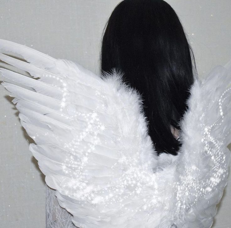 the back of a woman's head with white wings