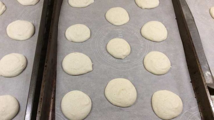 several pans filled with dough on top of metal trays