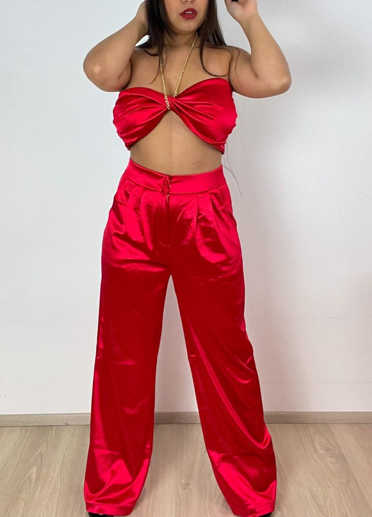 Detail - Satin Crop Top with gold chain halter and palazzo pants. Content + Care - 90% Polyester - 10% Spandex - Hand wash cold Size & Fit Model is 5'1" and wears size medium. Model Size Bust Waist 36in 28-30in Red Satin Party Bottoms, Chic Satin Wide Leg Pants For Party, Chic Wide Leg Satin Pants For Party, Two-piece Wide Leg Party Sets, Party Two-piece Wide Leg Sets, Party Wide-leg Two-piece Sets, Summer Party Satin Wide Leg Pants, Elegant Wide Leg Pant Set For Party, Two-piece Wide Leg Pants For Night Out