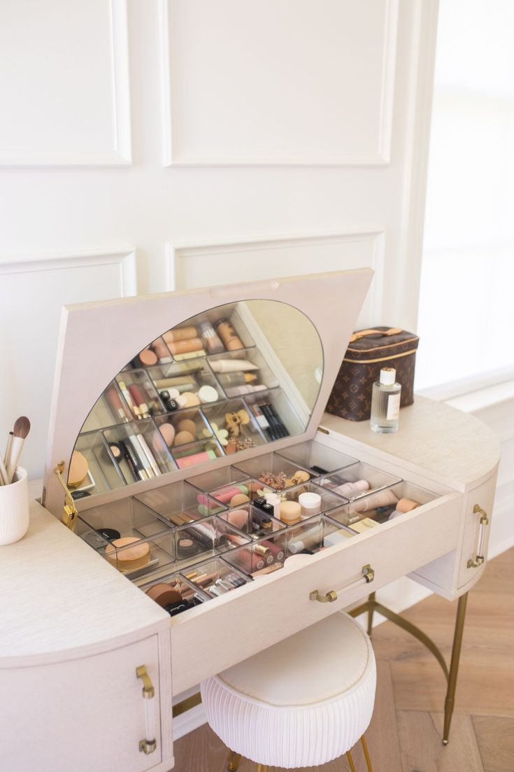 a white vanity with lots of makeup on it