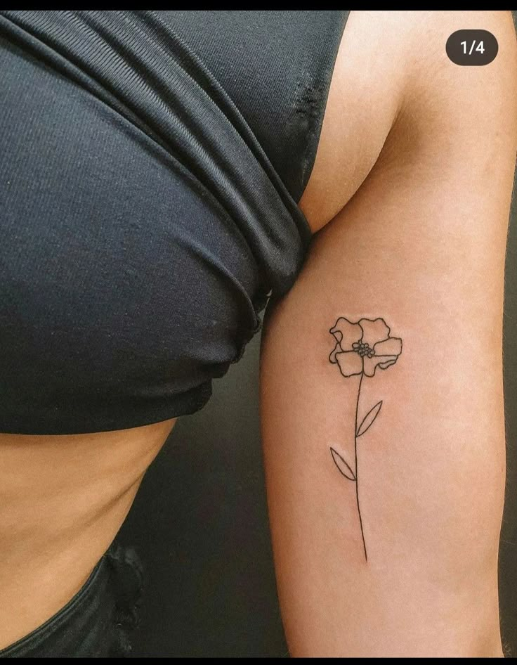 a woman's arm with a flower tattoo on the left side of her body