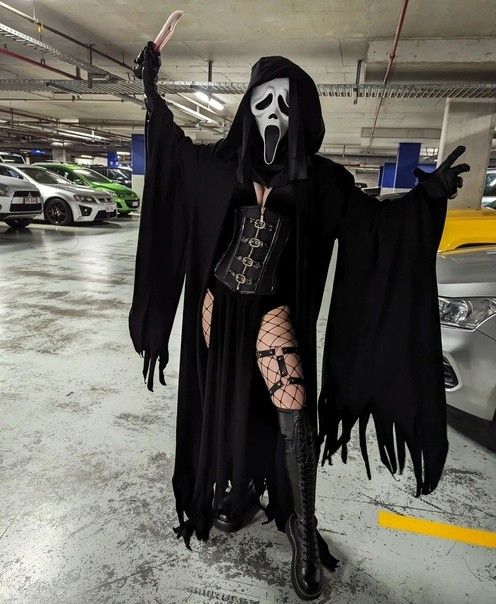 a woman dressed as a skeleton in a parking garage