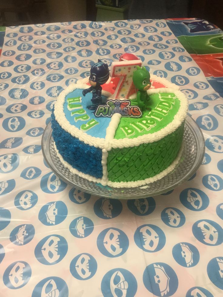 there is a cake on the table with blue and green frosting