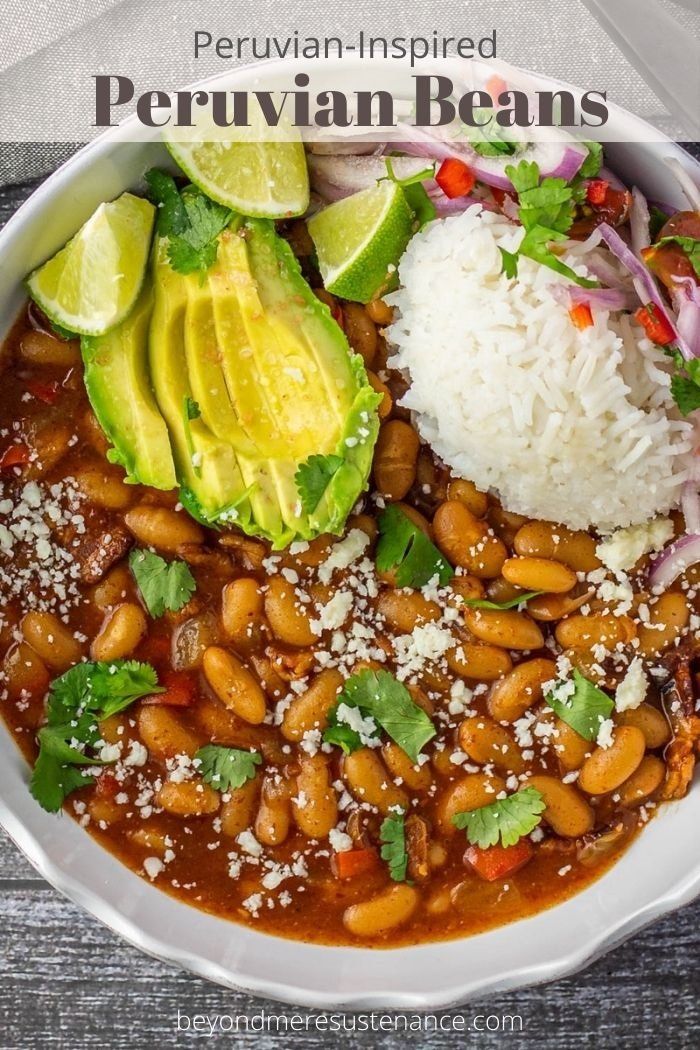 a white bowl filled with beans, rice and avocado