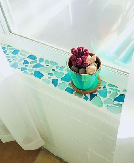 a potted plant sitting on top of a window sill