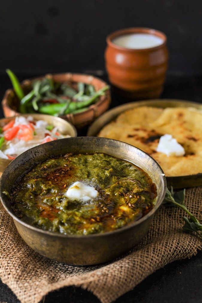 some food is sitting on top of a cloth next to bowls and plates with different foods in them