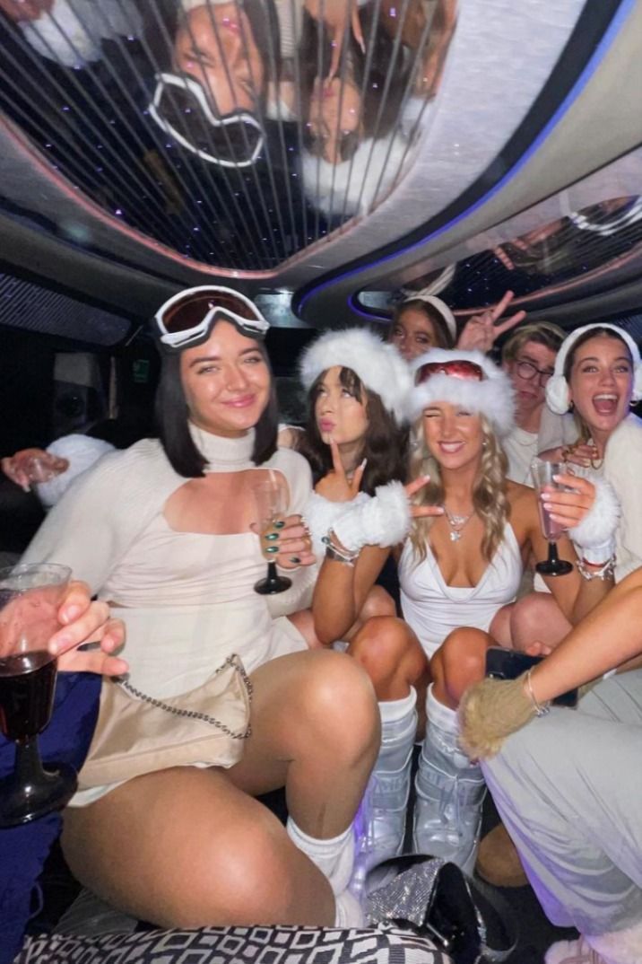 a group of women dressed up in costume posing for a photo on a party bus