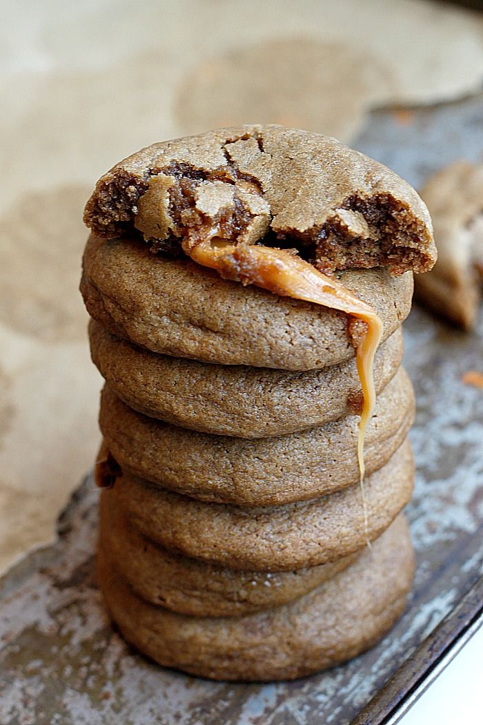 a stack of cookies sitting on top of a pan covered in caramel drizzle