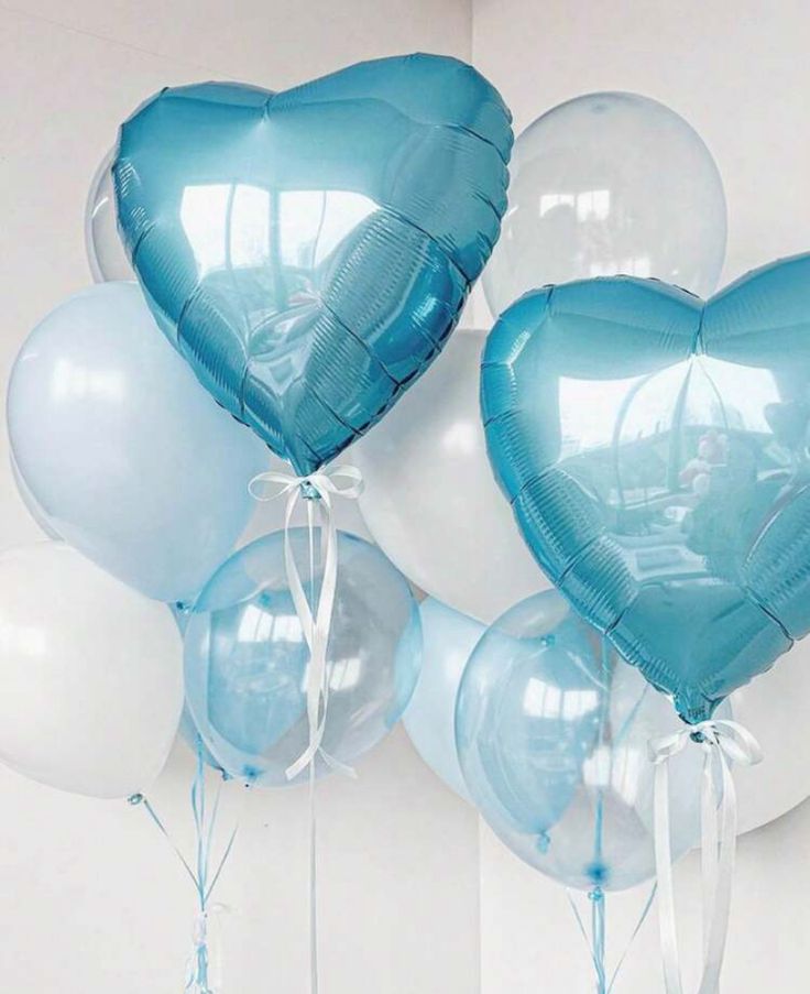 several blue and white balloons in the shape of hearts