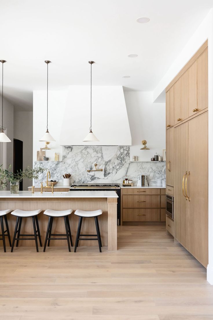 a kitchen with marble counter tops and stools