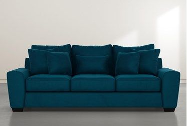 a blue couch sitting in front of a white wall