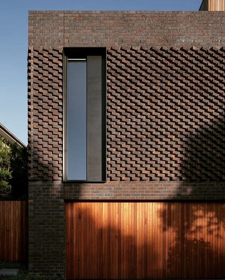 a brick building with a wooden garage door