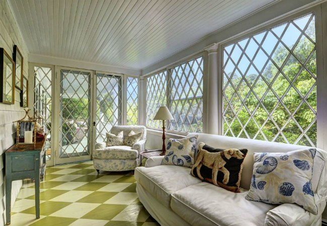 a living room filled with furniture and lots of windows