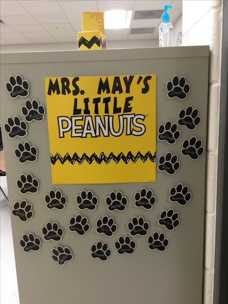 a bulletin board with dog paw prints and a sign that says, mrs may's little peanuts