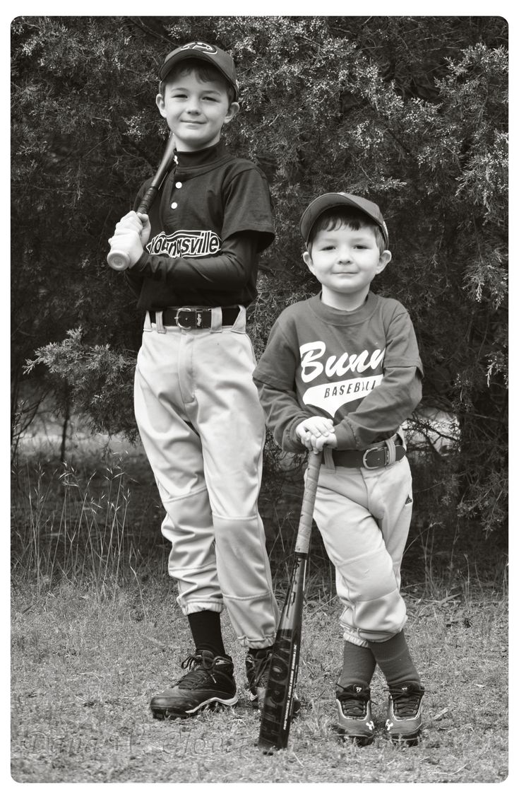 two young baseball players standing next to each other