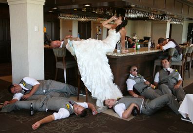 the bride and groom are laying on the floor in front of their friends at the bar