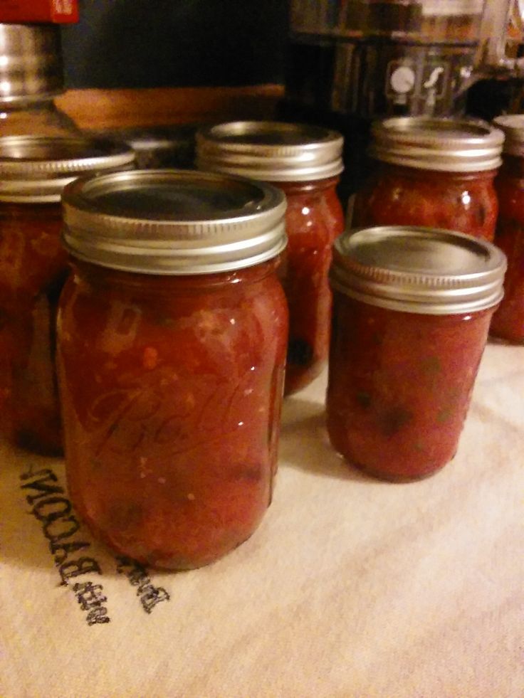 several jars filled with food sitting on top of a table