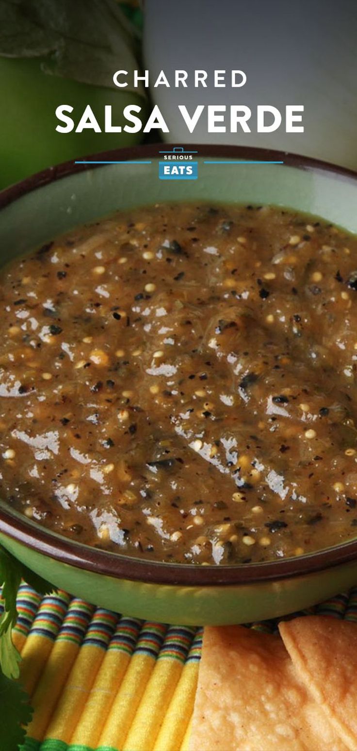 a bowl of salsa with tortilla chips on the side