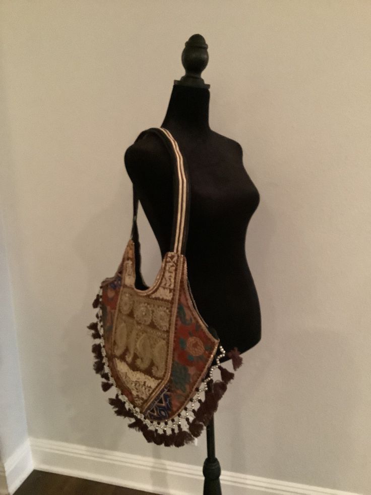 "Boho shoulder bag. Cotton bag with shear material on outside that is embroidered. Colors are brown, gold, and touches of deep blue and peach.  The opposite side is similar but also has some touches of red and green embroidery.  Unique and elegant piece. 15\" height, 18\" length" Brown Embroidered Hobo Shoulder Bag, Embroidered Brown Hobo Shoulder Bag, Vintage Beige Embroidered Shoulder Bag, Multicolor Embroidered Hobo Shoulder Bag For Travel, Embroidered Brown Hobo Bag, Embroidered Brown Tote Hobo Bag, Embroidered Brown Hobo Tote Bag, Travel-ready Multicolor Embroidered Hobo Shoulder Bag, Multicolor Embroidered Shoulder Hobo Bag For Travel