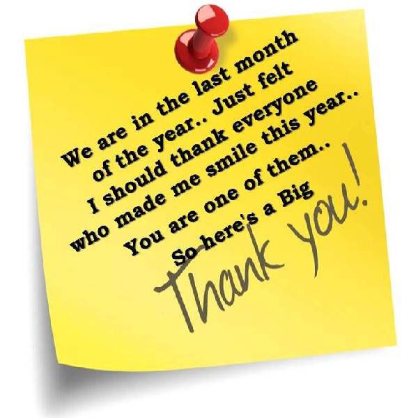 a note pinned to a yellow post - it with the words thank you written on it