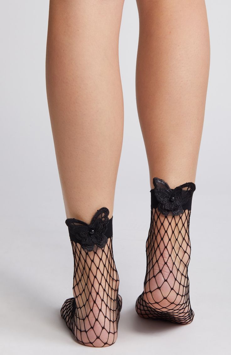 Lace butterflies centered with pearly beads put a whimsical spin on sassy fishnet socks edged by a wide band for a secure, comfortable fit. Nylon/spandex Hand wash, line dry Imported Stretch Mesh Fishnet Socks, Stretch Fishnet Mesh Socks, Stretch Fishnet Socks Made Of Mesh, Stretchable Fishnet Mesh Socks, Black Mesh Socks For Summer, Party Fishnet Socks, Spring Fishnet Socks, Fitted Fishnet Socks For Spring, Black Party Socks For Spring