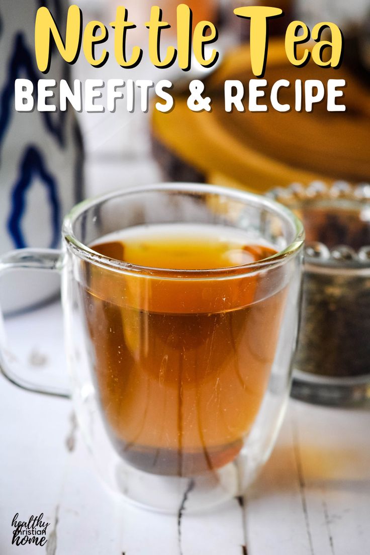 a glass cup filled with tea sitting on top of a table