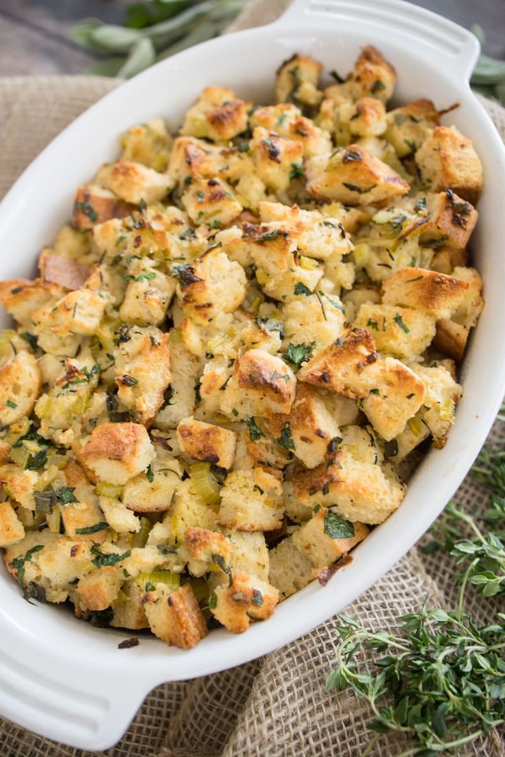 a casserole dish filled with stuffing and herbs