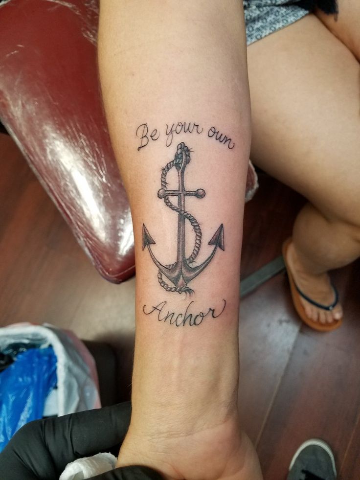 a woman with a tattoo on her arm that reads be your own anchor and an anchor