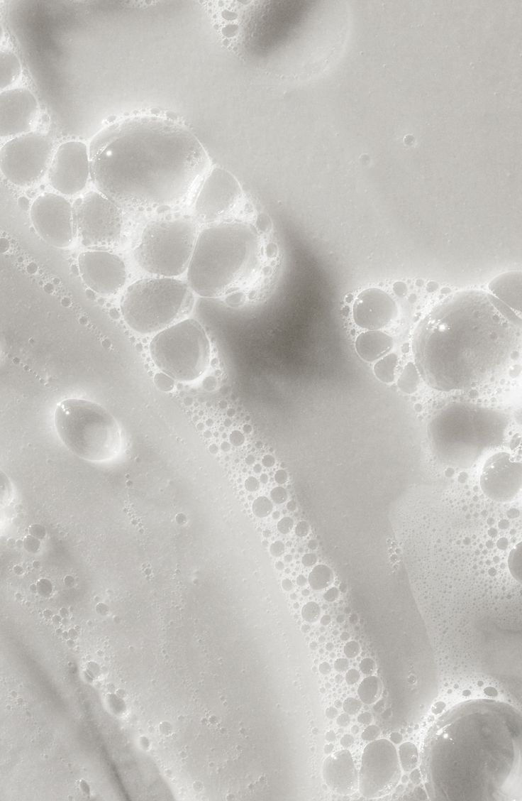 an image of water bubbles in the air on a white surface that looks like something out of space