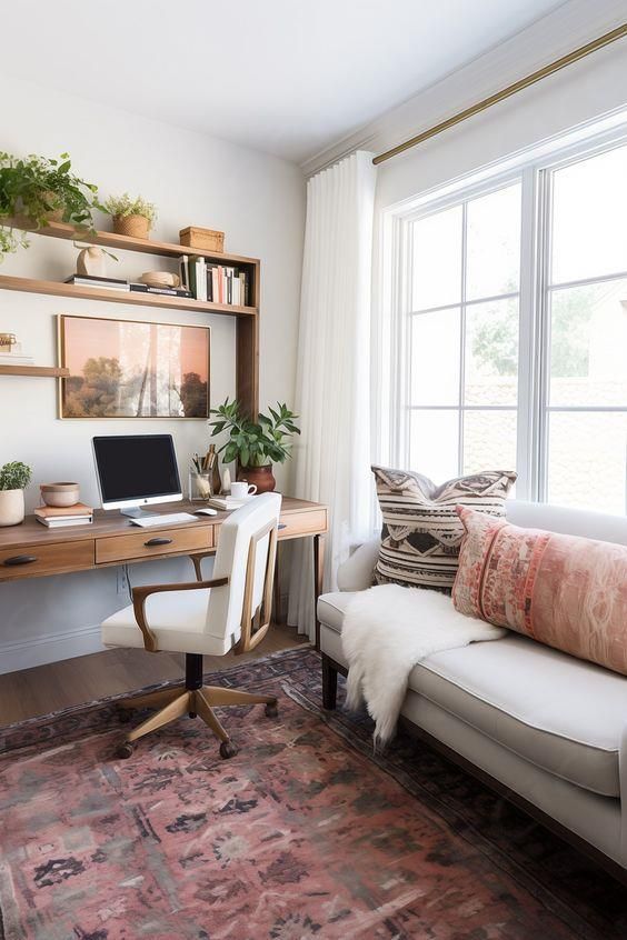 a living room with a couch, computer desk and bookshelf filled with plants