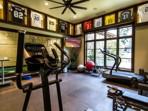 an exercise room with treadmills and windows