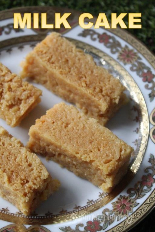 three pieces of cake on a plate with the words milkcake written in front of it