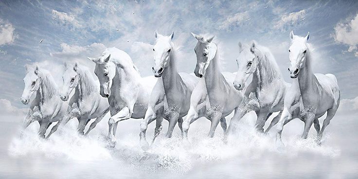 a group of white horses running through the water with clouds in the sky behind them