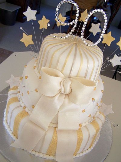 a white and gold birthday cake on a table