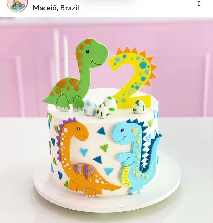 there is a cake decorated with dinosaurs on it