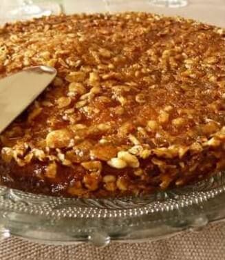 three different pictures of a cake with nuts on top and bottom, including one slice missing