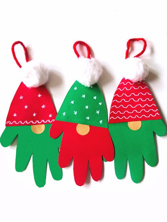 three handprinted christmas hats on top of each other with red and green pom - poms