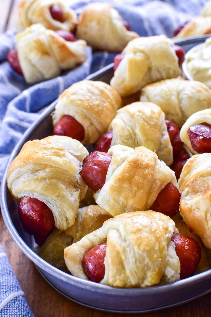 hotdogs wrapped in crescented bread on a wooden table