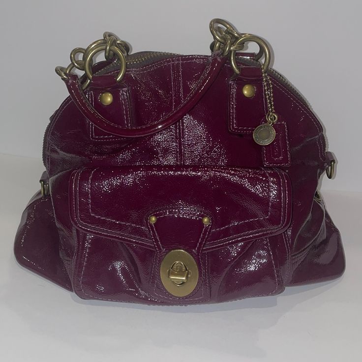 Coach Francine Patent Leather Bag In Purple. Comes With Shoulder Strap. Worn A Couple Dozen Times. Some Stains On Inside Legacy Stripe Lining. Front Turn Lock Works Perfectly. Some Splitting In The Patent Leather Which Is Pictured, To List Some Front Pocket, Front Lower Left, Back Pocket Seam, Back Right Near Zipper. About 16 Inches Wide, About 12 Inches Tall To Highest Point At Center. Limited Edition Bag Purchased At King Of Prussia Store Location. In Pictures Bag Is Stuffed To Show Shape. Coach Purple Shoulder Bag With Top Carry Handle, Coach Purple Rectangular Shoulder Bag, Coach Rectangular Purple Shoulder Bag, Coach Purple Bags For On-the-go, Coach Rogue, Purple Shoulder Bag With Gold-tone Hardware For Shopping, Coach Satchel, Patent Leather Bag, Limited Edition Bag