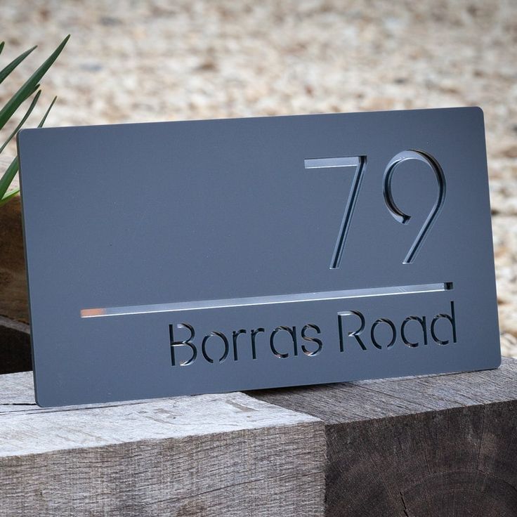 there is a sign that says borra's road on the side of a wooden block