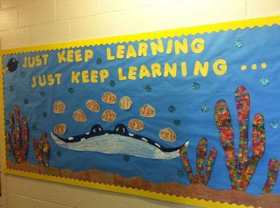 a bulletin board with an image of a crocodile on it and words that read just keep learning, just keep learning