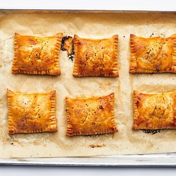 six small pastries sitting on top of a baking sheet