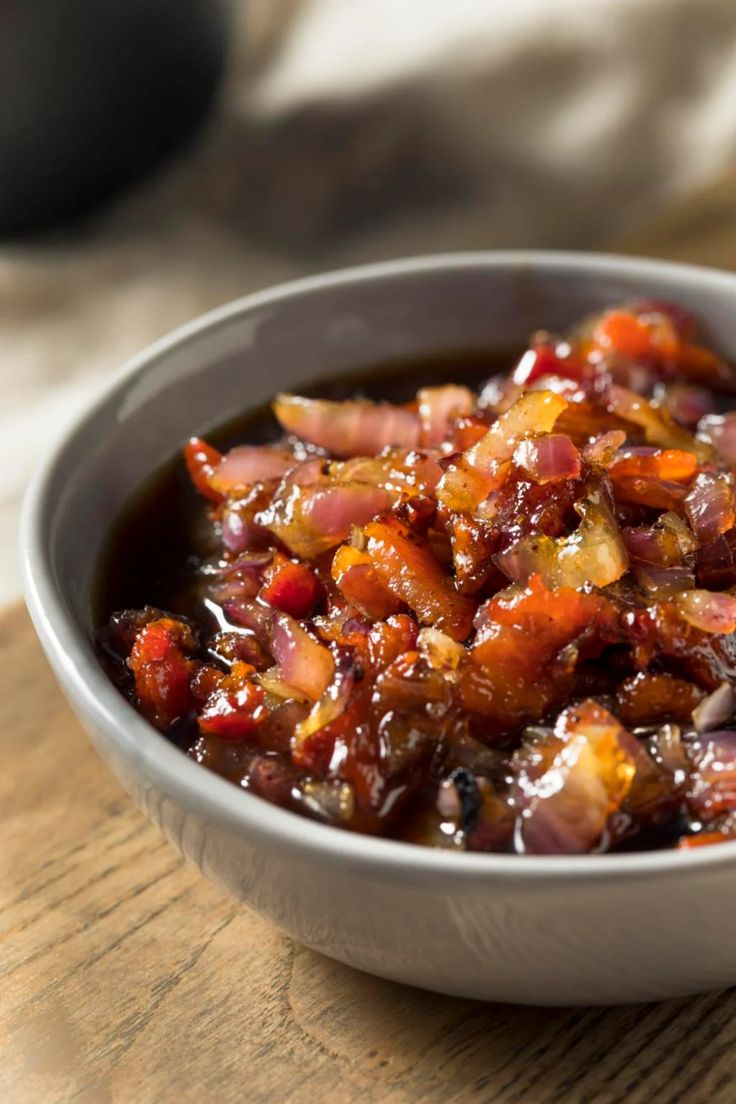 a bowl filled with food sitting on top of a wooden table