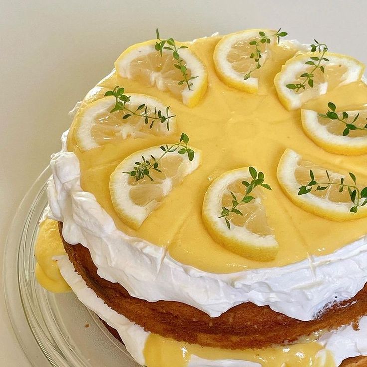 there is a cake with lemons on top and icing around the edges that are yellow