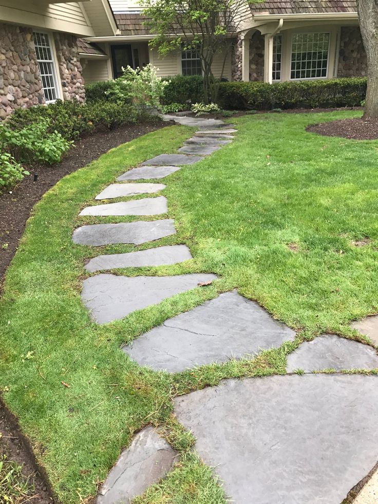 a stone path in front of a house