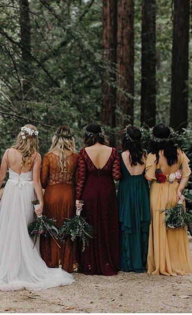 a group of women standing next to each other in the woods