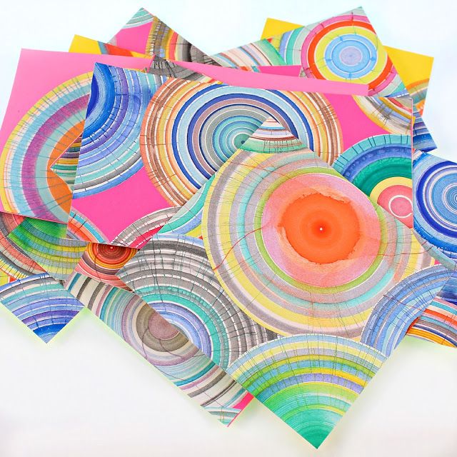 four colorful paper napkins are stacked on top of each other