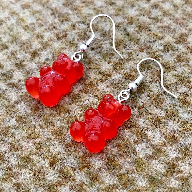 A pair of super cute Red Gummy Bear earrings.  The bears are made from resin so they are hard and long lasting.  They are very realistic so keep out of reach of children! Silver alloy hooks complete these lovey pieces. Cute Gummy Bear, Paw Keychain, Gummy Bear Earrings, Rainbow Keychain, Bear Earrings, Elephant Earrings, Angel Wing Earrings, Silver Elephants, Elephant Charm