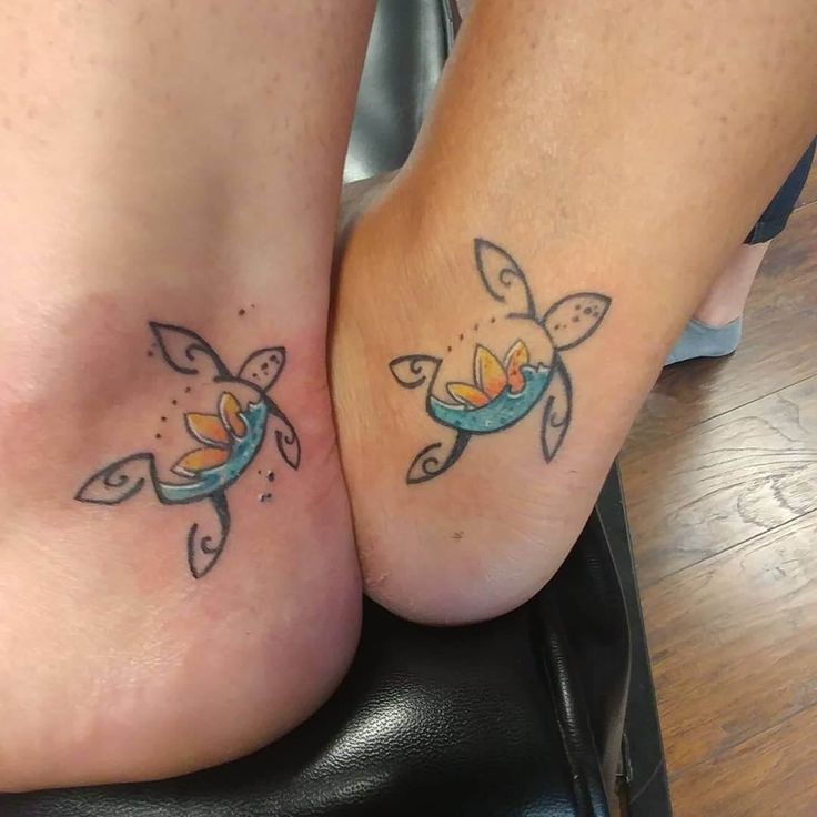 two people with matching tattoos on their feet, one has a fish and the other has a turtle